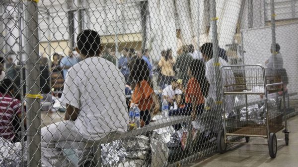 A photo provided by U.S. Customs and Border Protection shows people detained at a facility in McAllen, Texas, on Sunday.